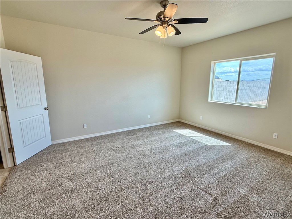 5392 Rattlesnake Road Kingman, AZ 86409 - Photo 16 of 35 an empty room with windows and fan