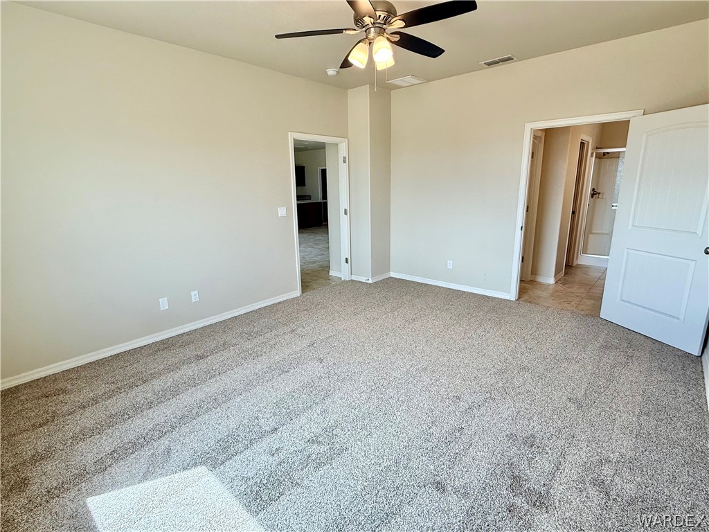 5392 Rattlesnake Road Kingman, AZ 86409 - Photo 18 of 35 a view of an empty room with a ceiling fan