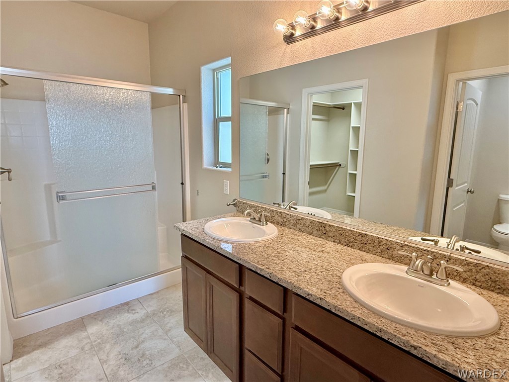 5392 Rattlesnake Road Kingman, AZ 86409 - Photo 19 of 35 a bathroom with a granite countertop sink and a mirror