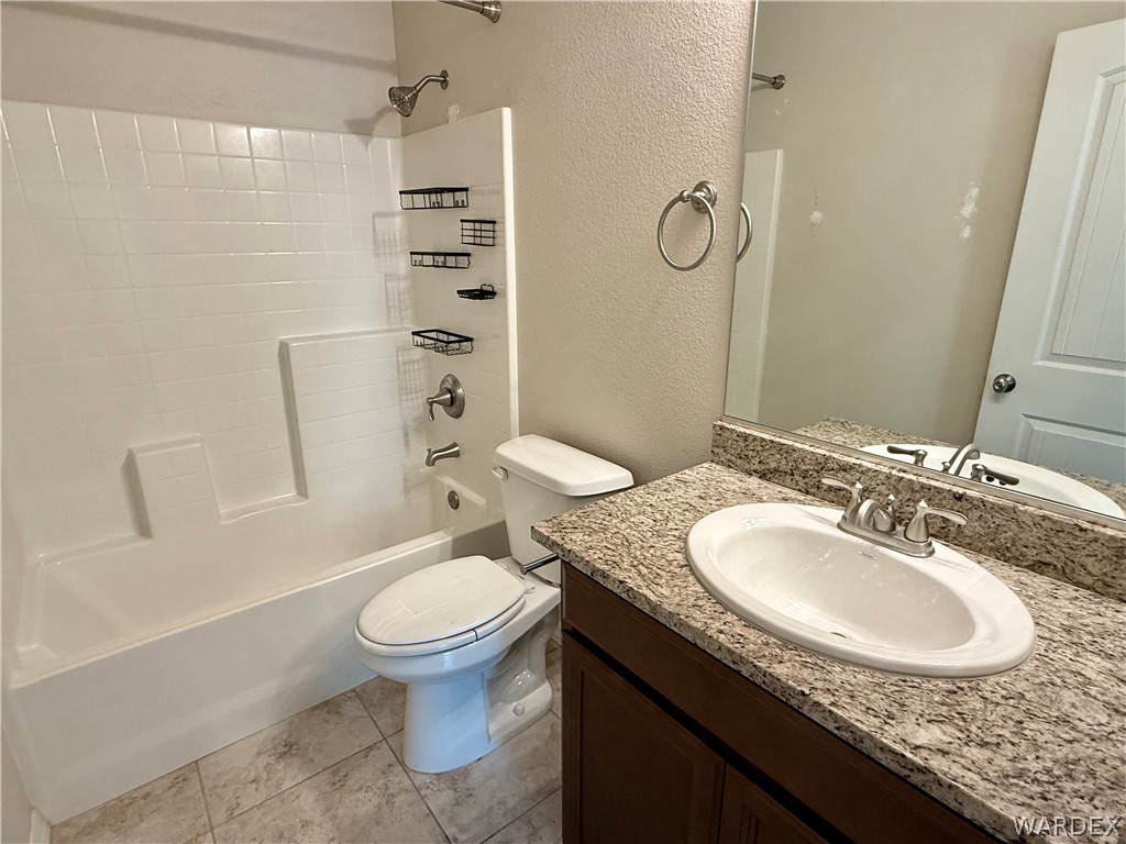 5392 Rattlesnake Road Kingman, AZ 86409 - Photo 22 of 35 a bathroom with a granite countertop sink a toilet and a mirror