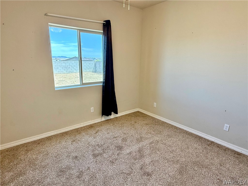 5392 Rattlesnake Road Kingman, AZ 86409 - Photo 23 of 35 an empty room with a window