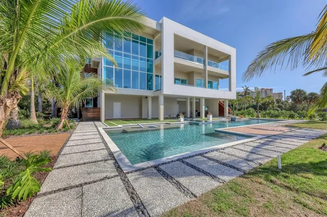a living room with furniture and a dining table with kitchen view