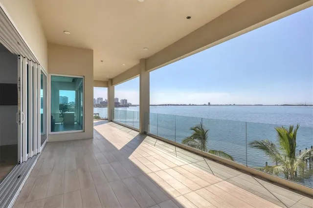 a view of a livingroom with hardwood floor and a large window