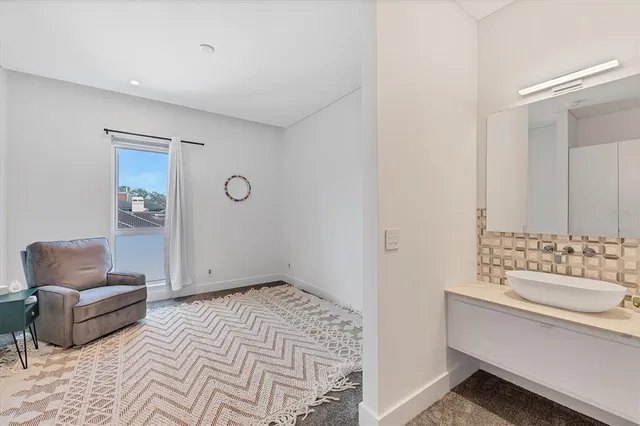 a workspace with furniture and a large window