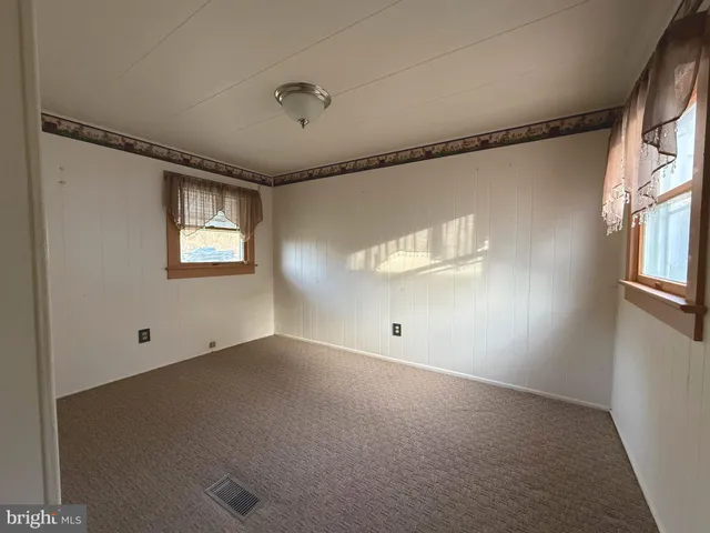 an empty room with windows and entrance