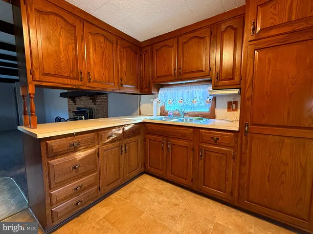 a kitchen with stainless steel appliances granite countertop wooden cabinets a sink and dishwasher