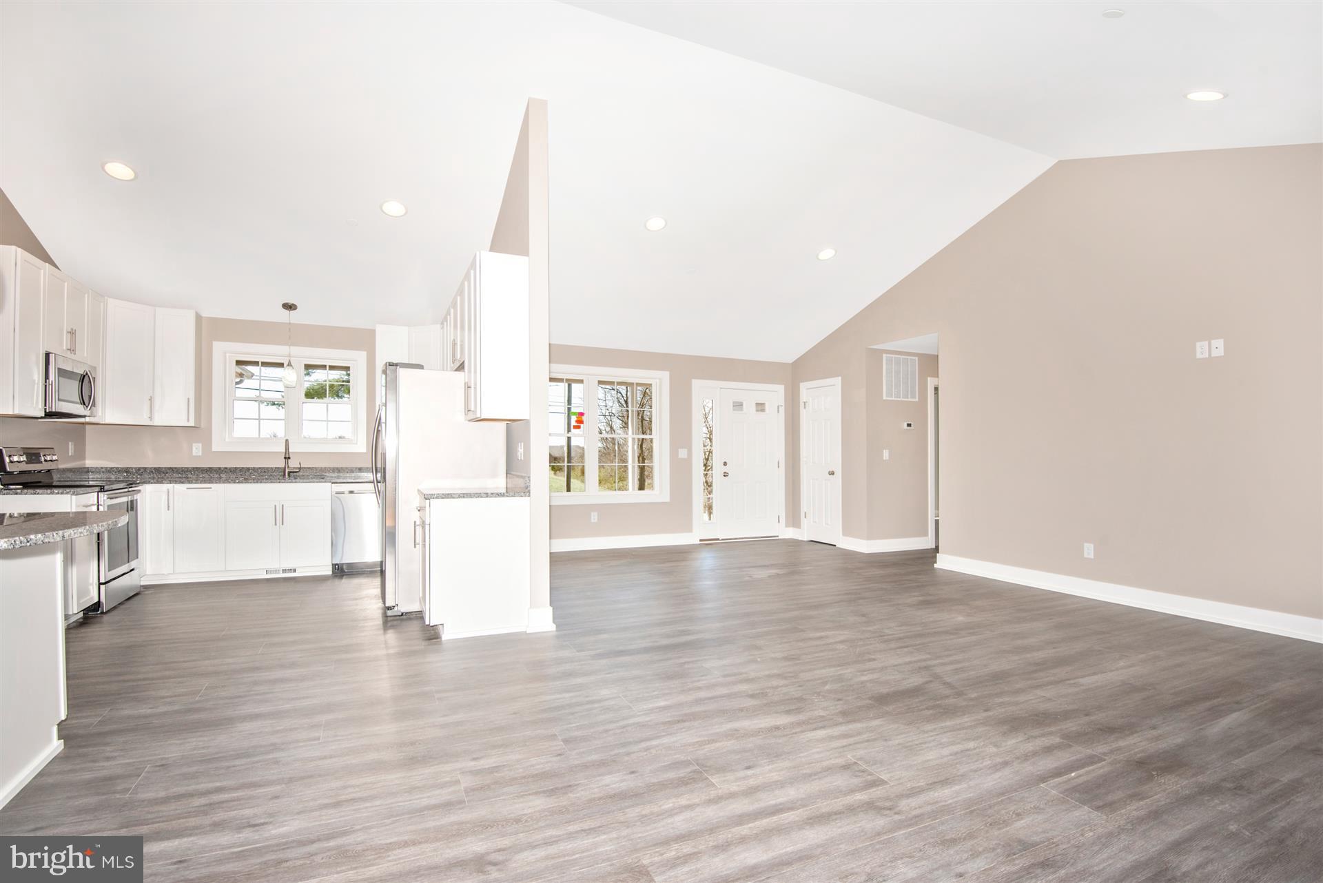 4235 Horine Road Jefferson, MD 21755 - Photo 12 of 24 a view of an empty room with wooden floor and a kitchen