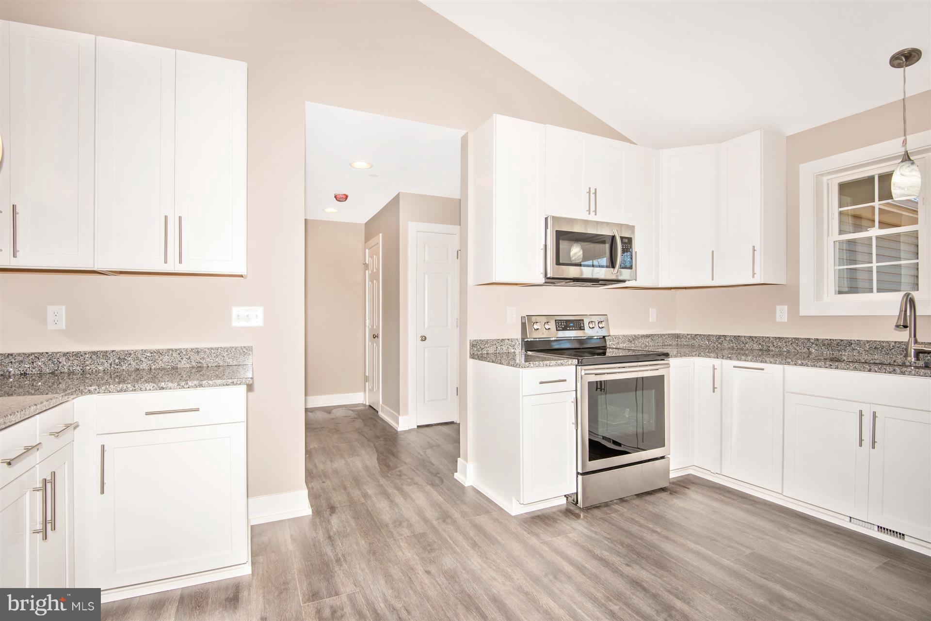 4235 Horine Road Jefferson, MD 21755 - Photo 15 of 24 a kitchen with granite countertop white cabinets and white appliances