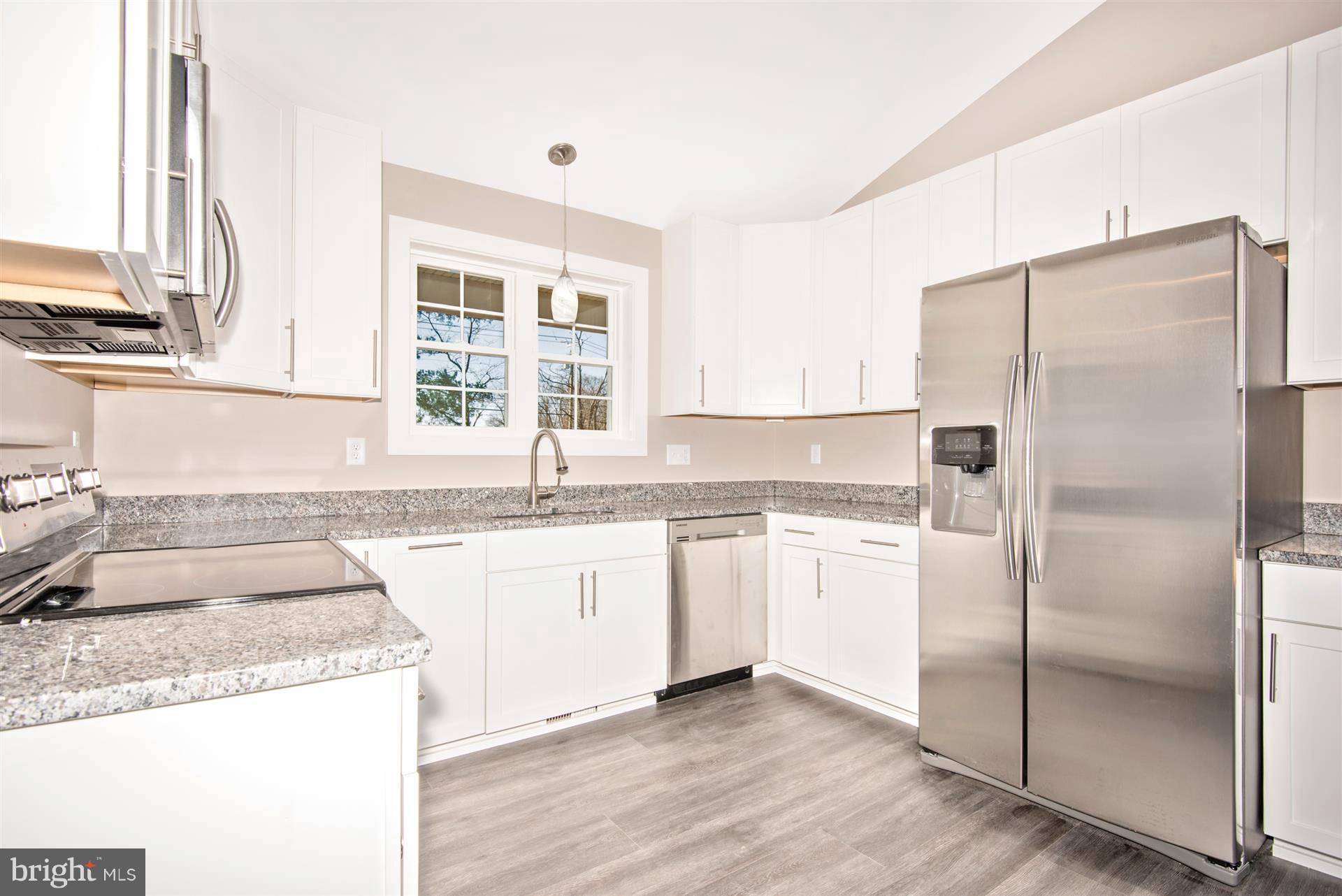 4235 Horine Road Jefferson, MD 21755 - Photo 16 of 24 a kitchen with granite countertop a refrigerator and a sink