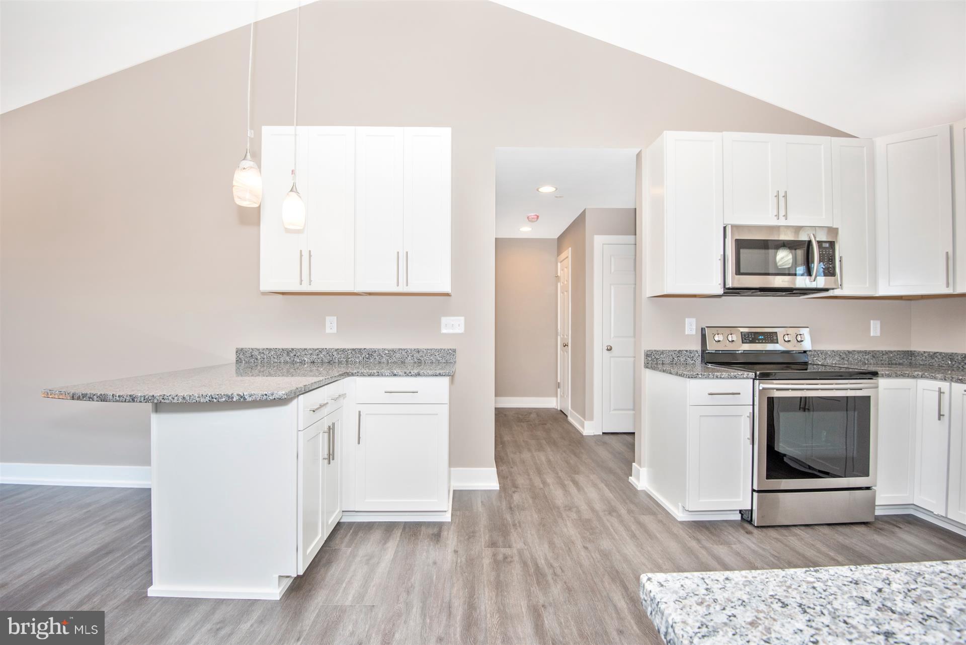 4235 Horine Road Jefferson, MD 21755 - Photo 18 of 24 a kitchen with stainless steel appliances granite countertop a stove a sink and a microwave