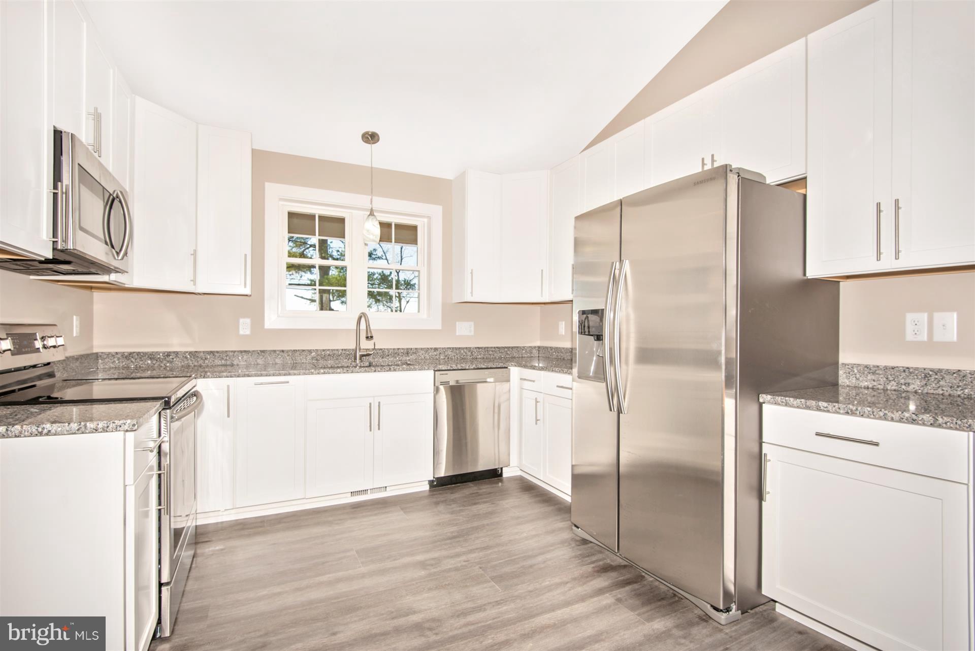 4235 Horine Road Jefferson, MD 21755 - Photo 19 of 24 a kitchen with granite countertop a refrigerator sink and cabinets
