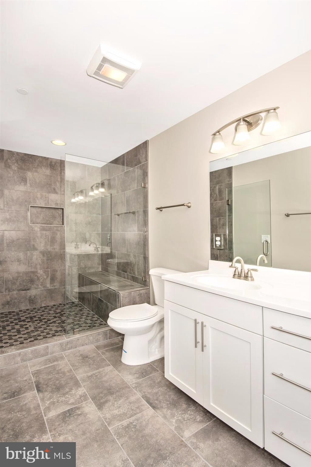 4235 Horine Road Jefferson, MD 21755 - Photo 21 of 24 a bathroom with a double vanity sink toilet and shower