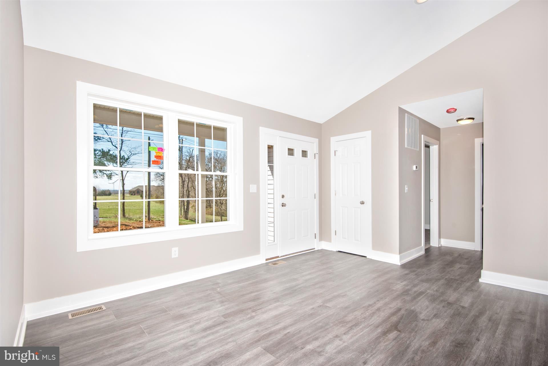 4235 Horine Road Jefferson, MD 21755 - Photo 8 of 24 an empty room with wooden floor and windows