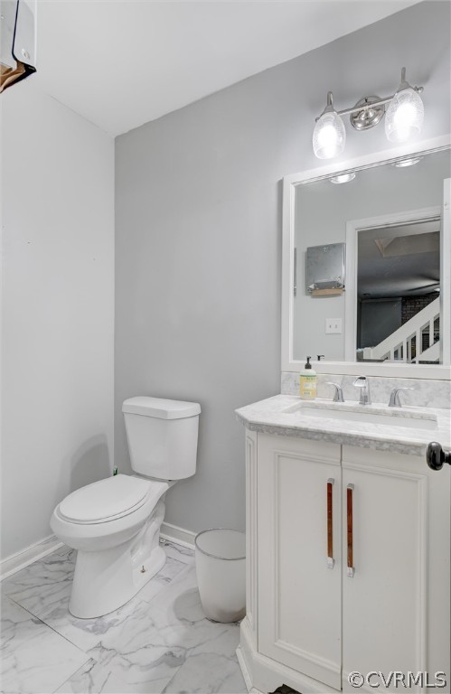 10731 Timberun Road Chesterfield, VA 23832 - Photo 11 of 25 a bathroom with a toilet a sink and mirror