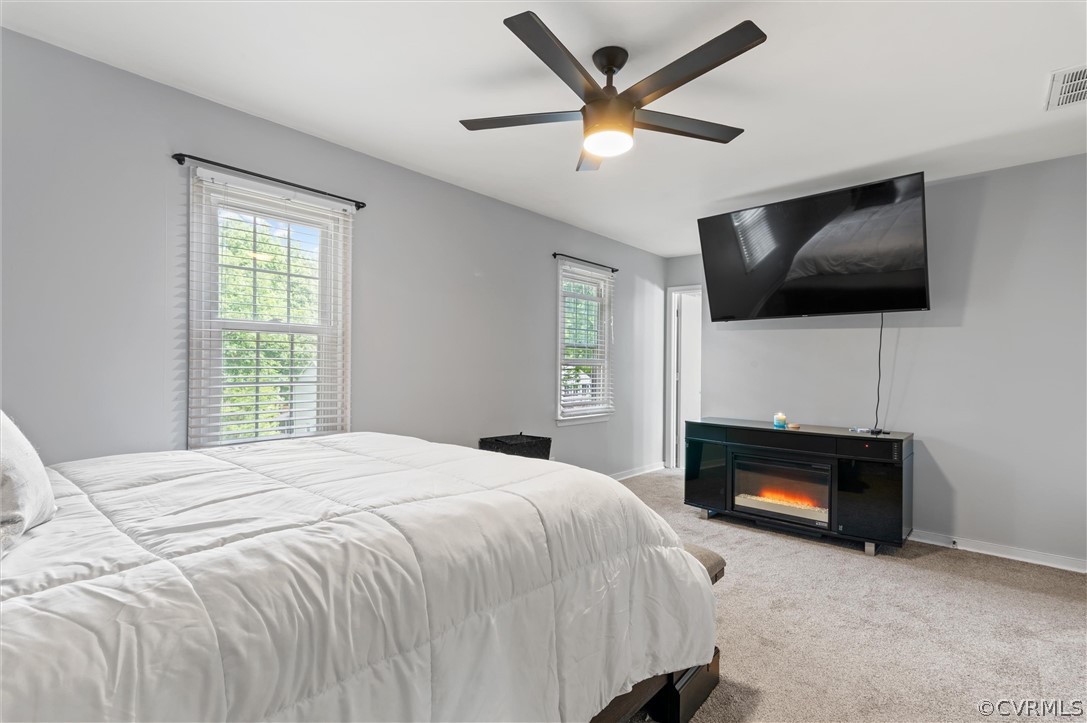 10731 Timberun Road Chesterfield, VA 23832 - Photo 17 of 25 a bedroom with a bed a flat screen tv and a fireplace