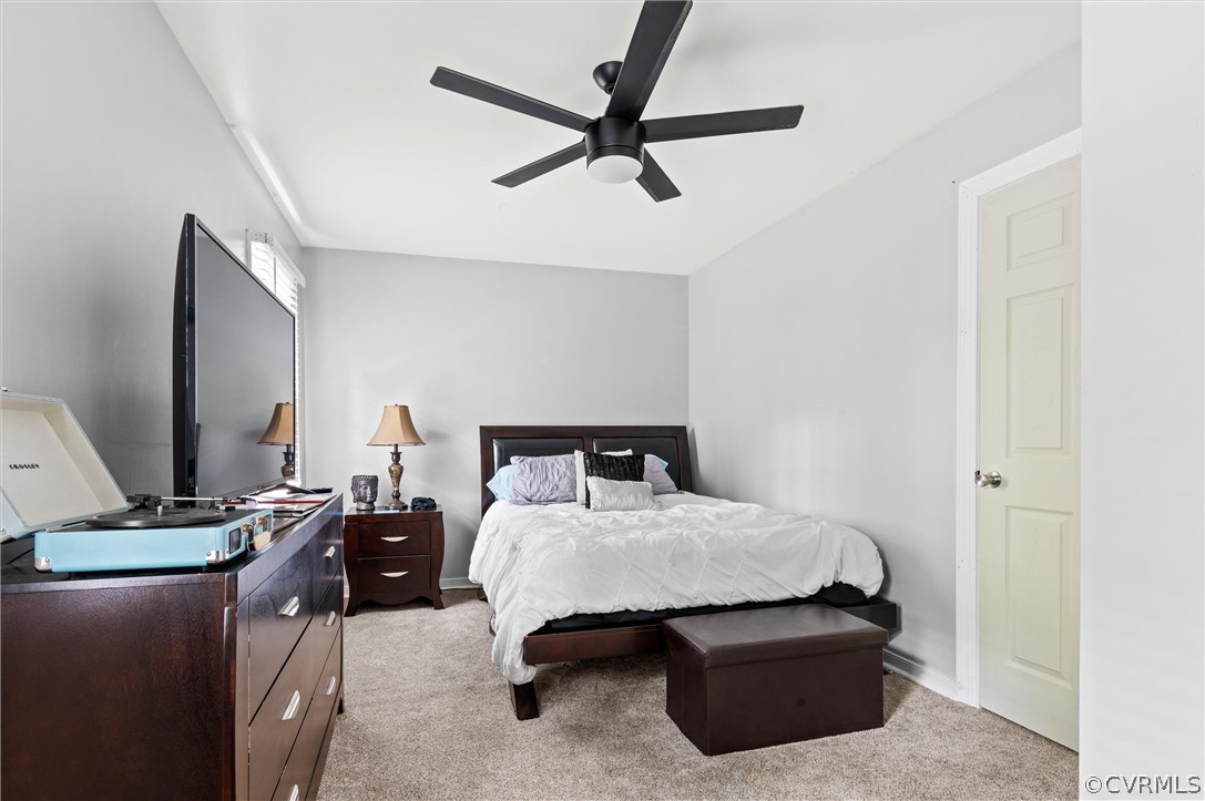 10731 Timberun Road Chesterfield, VA 23832 - Photo 20 of 25 a bedroom with a bed and a flat tv screen on the dresser