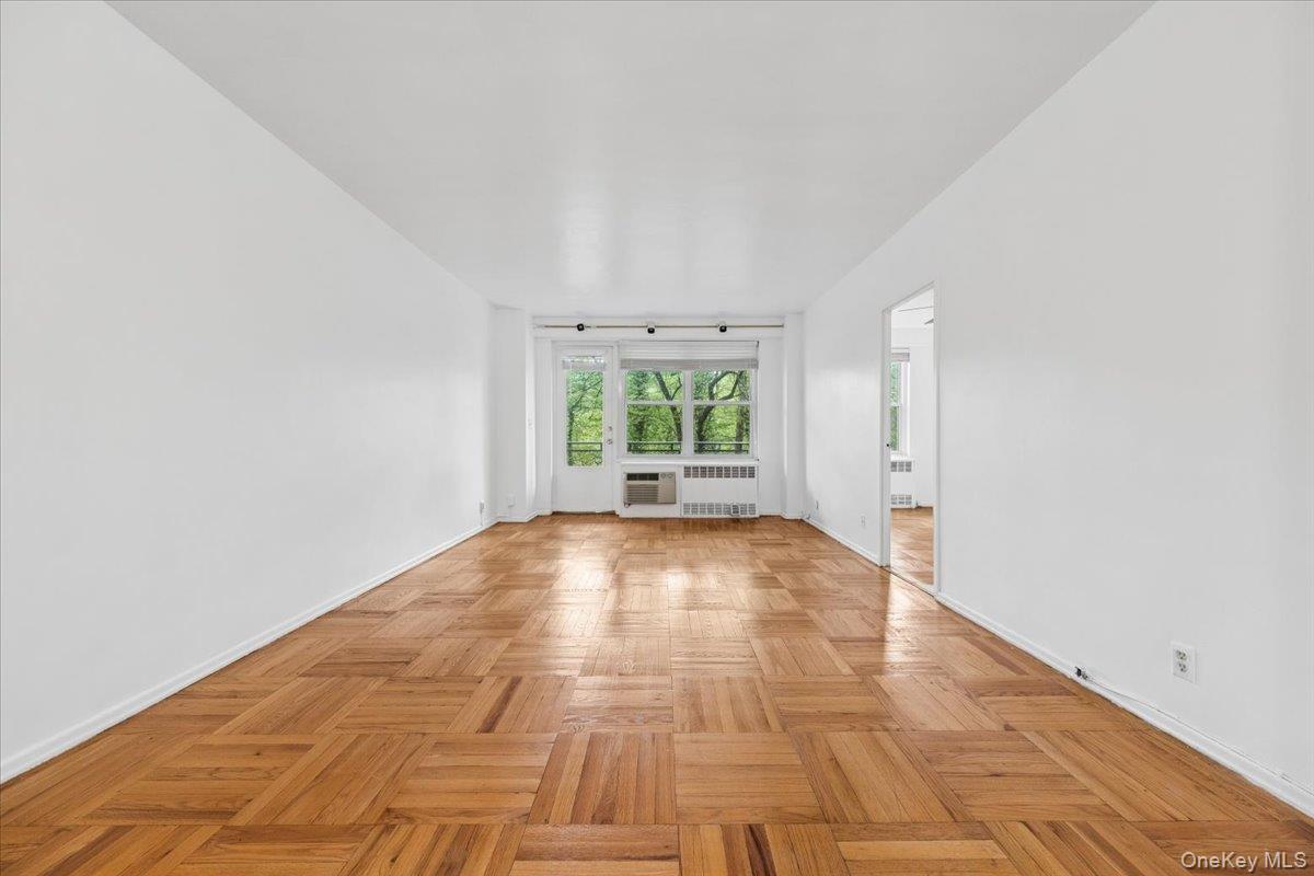 281 Garth Road, Unit C2H Scarsdale, NY 10583 - Photo 11 of 38 a view of a room with wooden floor and window