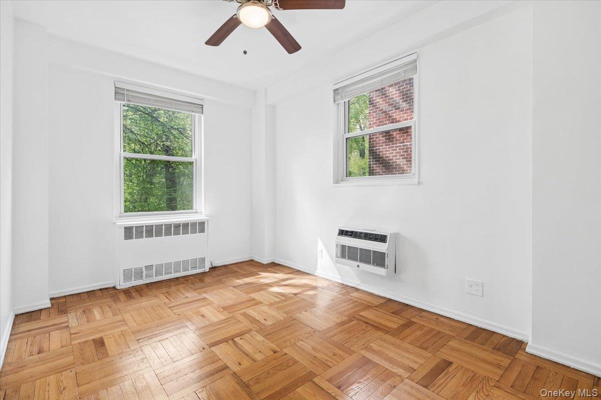 281 Garth Road, Unit C2H Scarsdale, NY 10583 - Photo 16 of 38 a bedroom with a bed and a window
