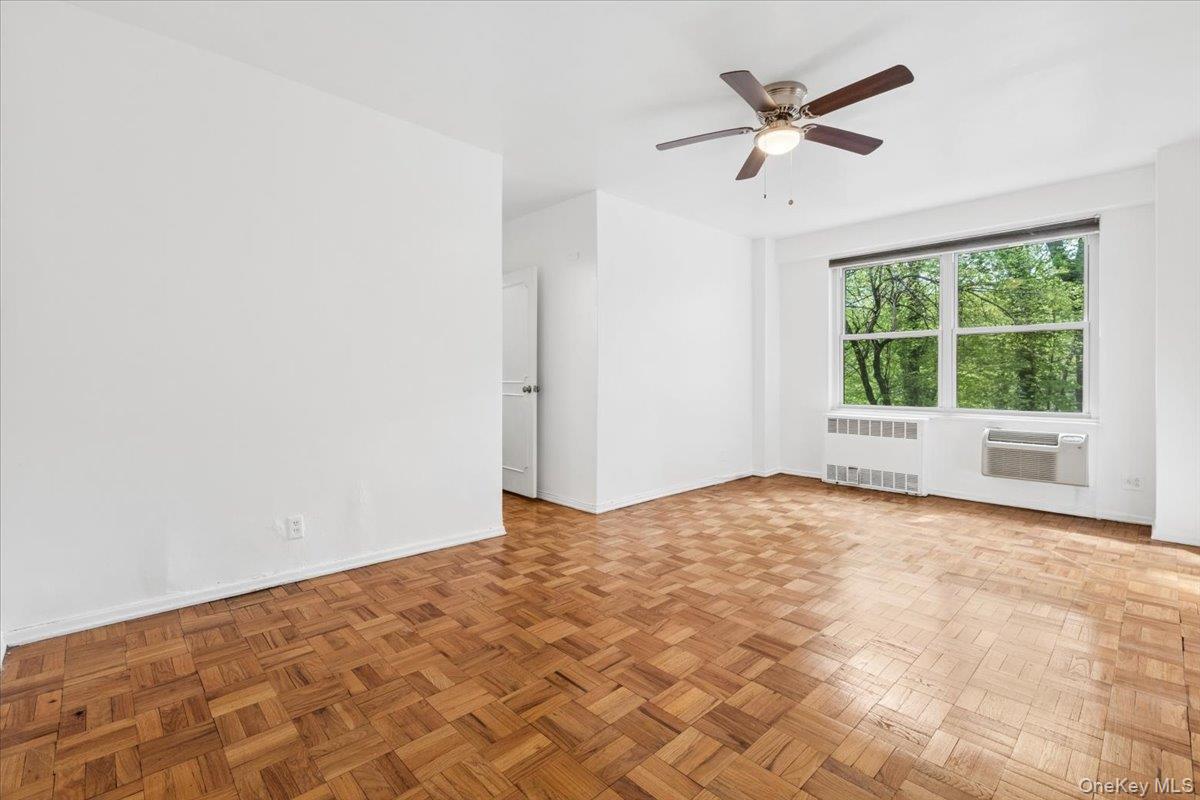 281 Garth Road, Unit C2H Scarsdale, NY 10583 - Photo 20 of 38 a view of a livingroom with a ceiling fan and window