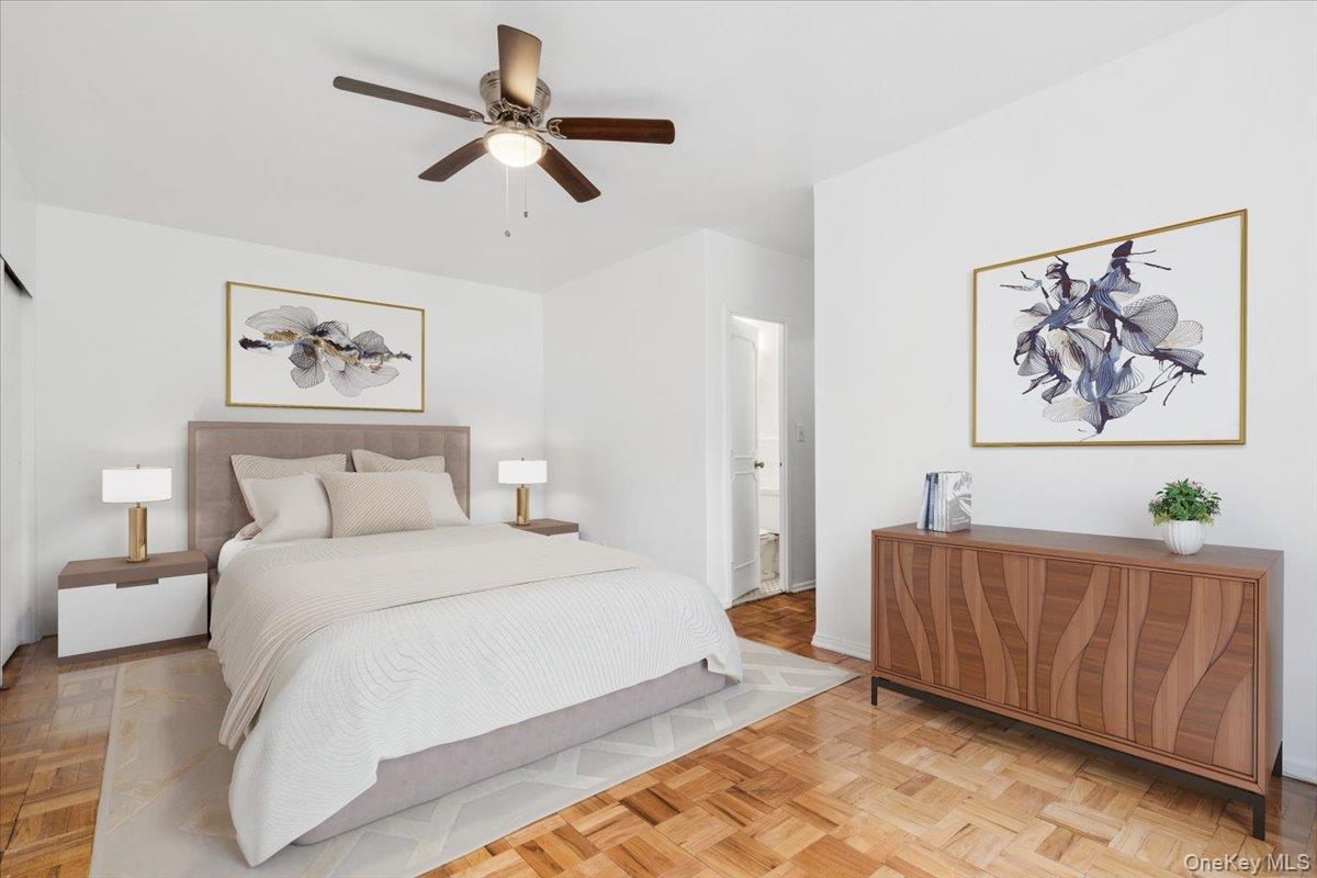 281 Garth Road, Unit C2H Scarsdale, NY 10583 - Photo 22 of 38 a bedroom with a bed and a painting on the wall