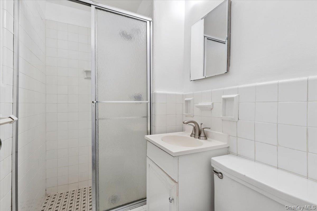 281 Garth Road, Unit C2H Scarsdale, NY 10583 - Photo 24 of 38 a bathroom with a sink toilet and shower