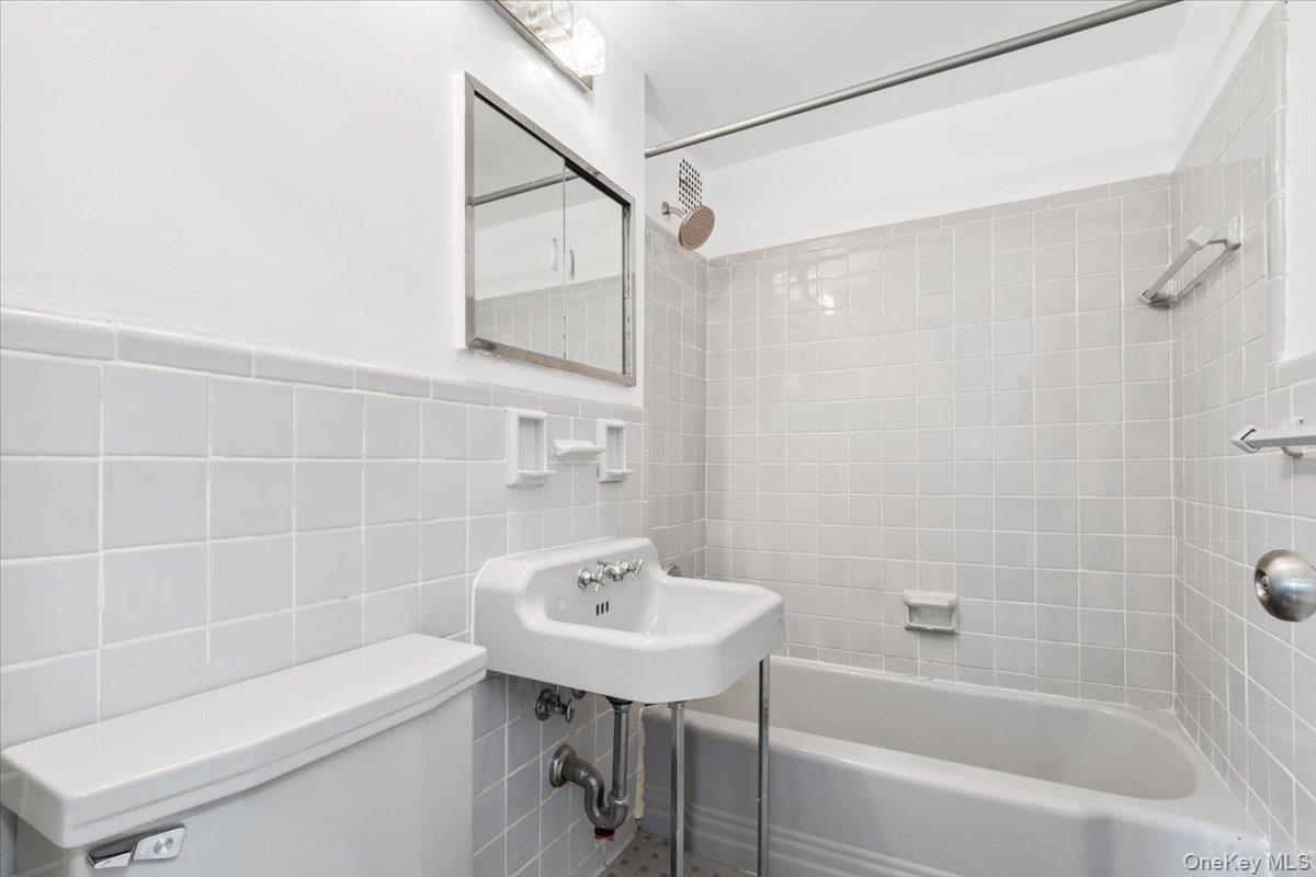 281 Garth Road, Unit C2H Scarsdale, NY 10583 - Photo 25 of 38 a bathroom with a sink a toilet and shower