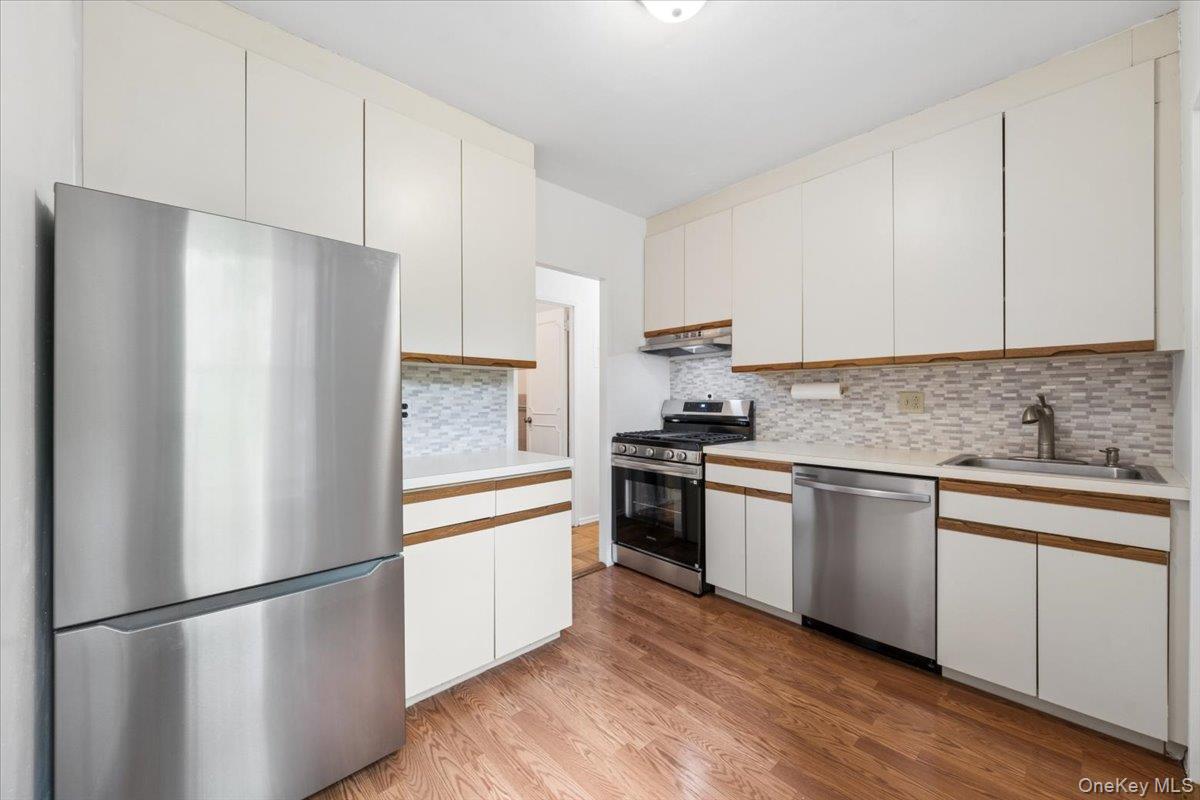 281 Garth Road, Unit C2H Scarsdale, NY 10583 - Photo 28 of 38 a kitchen with stainless steel appliances a refrigerator sink and cabinets