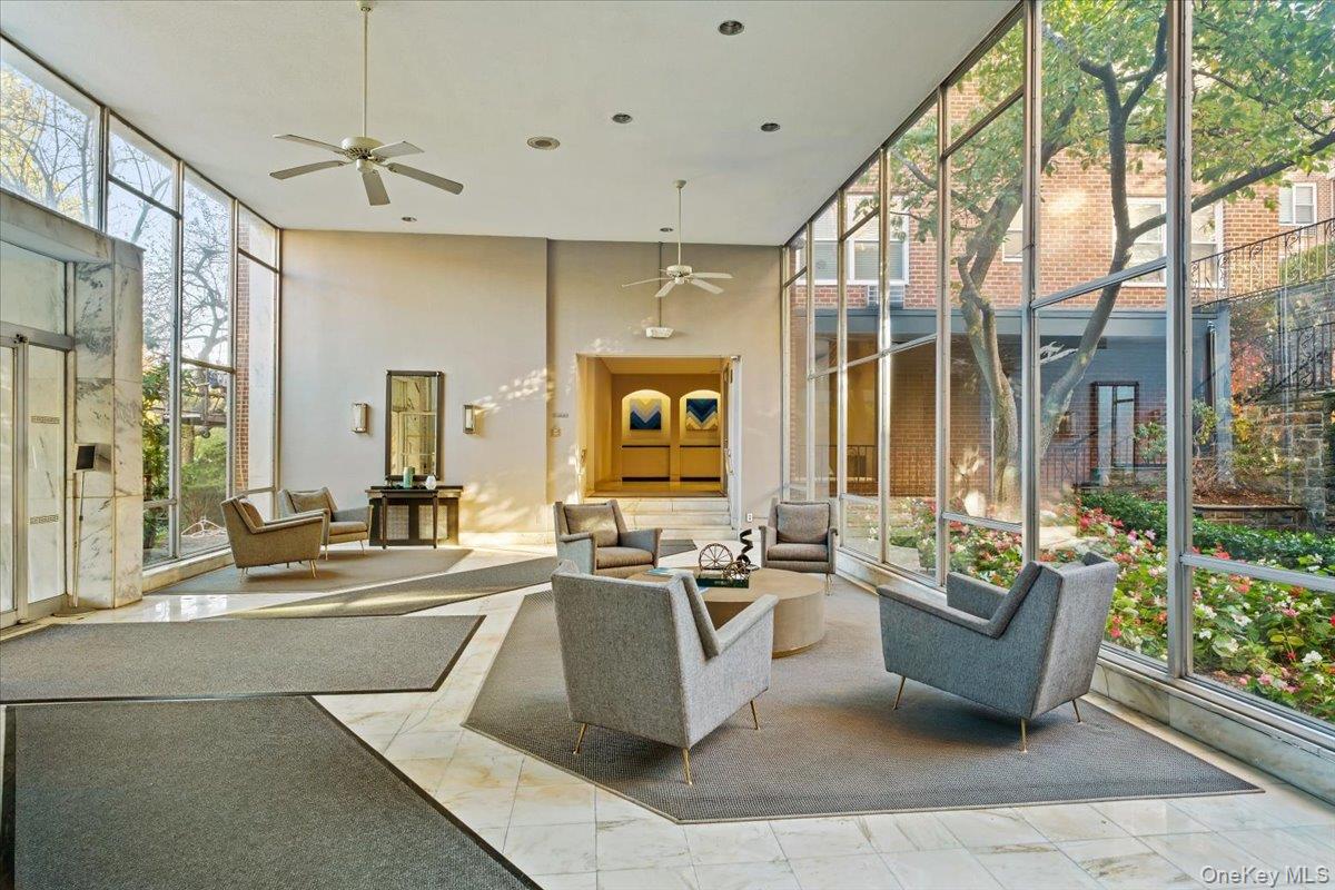 281 Garth Road, Unit C2H Scarsdale, NY 10583 - Photo 3 of 38 a living room with furniture and a large window