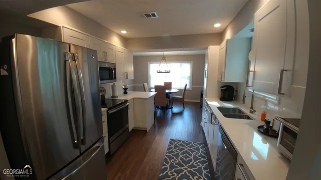 a kitchen with sink refrigerator and outdoor view