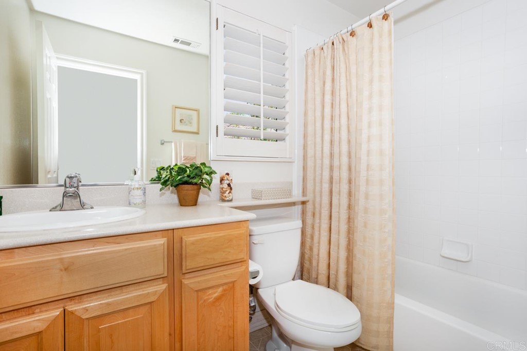 5560 Foxtail Loop Carlsbad, CA 92010 - Photo 13 of 32 a bathroom with a sink a toilet a mirror and shower
