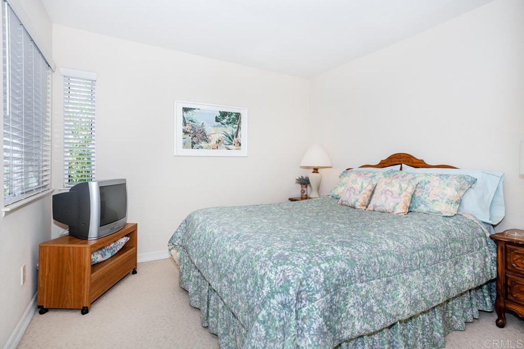5560 Foxtail Loop Carlsbad, CA 92010 - Photo 14 of 32 a bedroom with a bed and couch