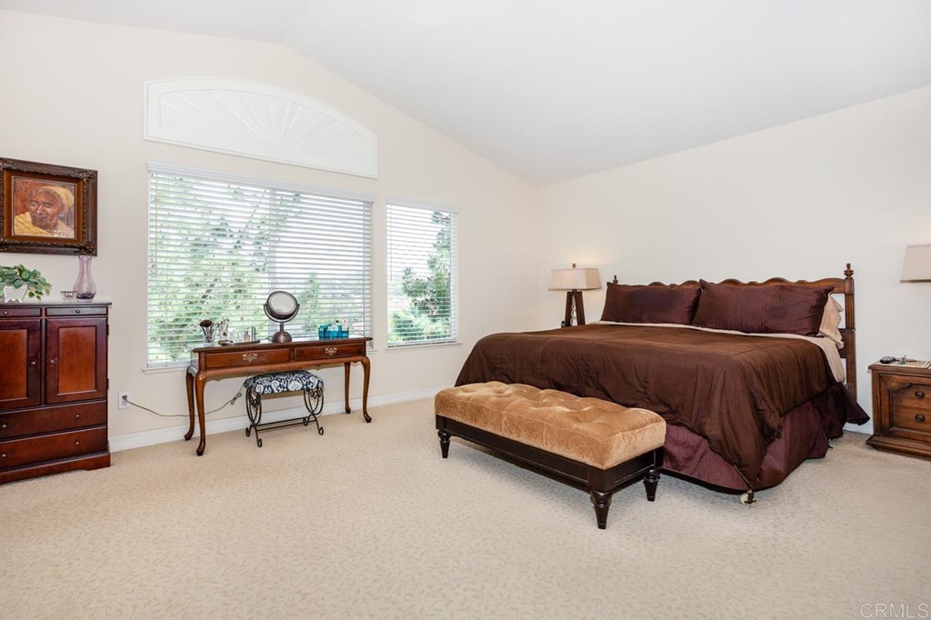 5560 Foxtail Loop Carlsbad, CA 92010 - Photo 15 of 32 a bedroom with a bed and a couch next to a window