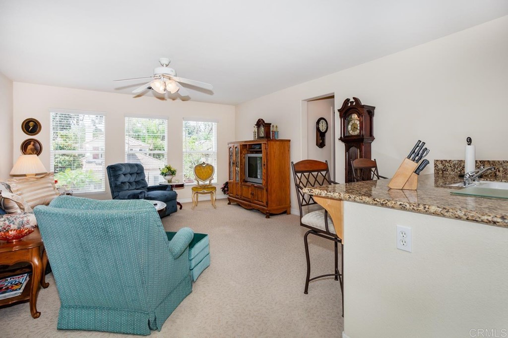 5560 Foxtail Loop Carlsbad, CA 92010 - Photo 21 of 32 a living room with furniture and a flat screen tv