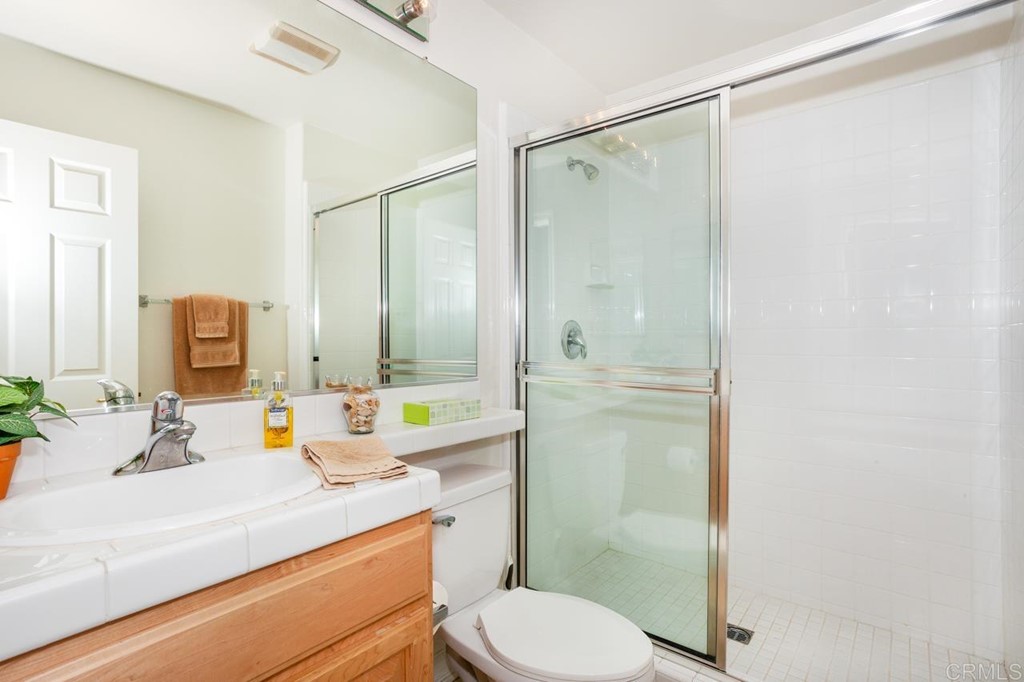 5560 Foxtail Loop Carlsbad, CA 92010 - Photo 25 of 32 a bathroom with a sink toilet and shower