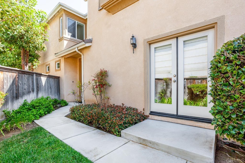 5560 Foxtail Loop Carlsbad, CA 92010 - Photo 31 of 32 a front view of a house with garden