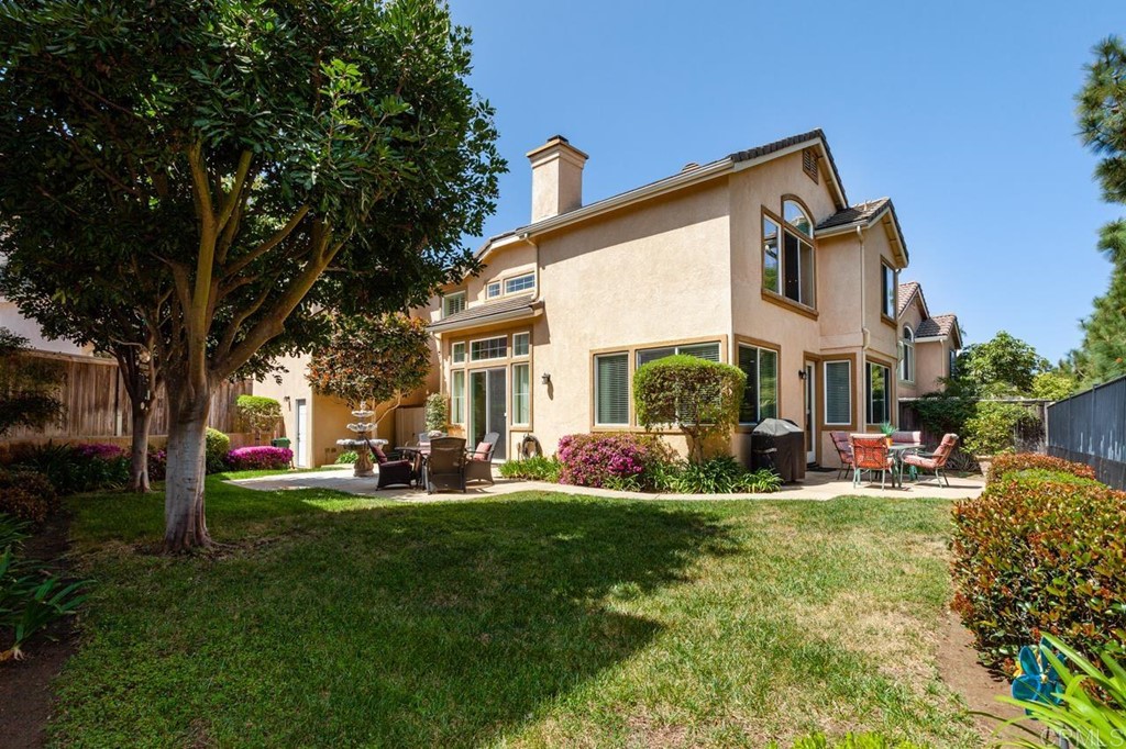 5560 Foxtail Loop Carlsbad, CA 92010 - Photo 32 of 32 a view of a house with backyard sitting area and garden