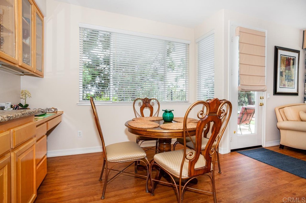 5560 Foxtail Loop Carlsbad, CA 92010 - Photo 6 of 32 a view of a dining room with furniture and wooden floor