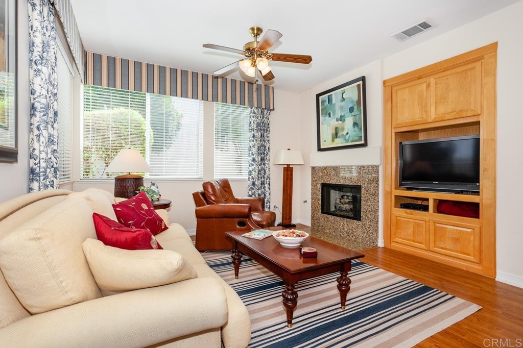 5560 Foxtail Loop Carlsbad, CA 92010 - Photo 8 of 32 a living room with furniture fireplace and flat screen tv