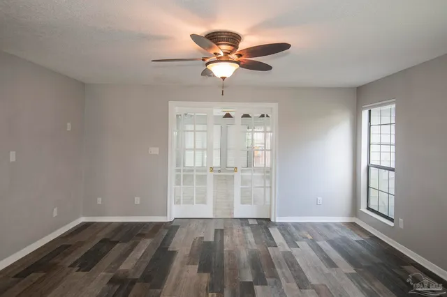 wooden floor in an empty room with a window