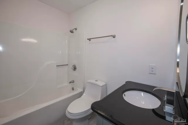 a bathroom with a toilet a sink and bathtub