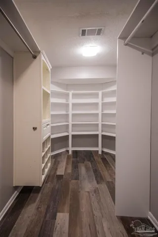 a view of walk in closet with empty racks