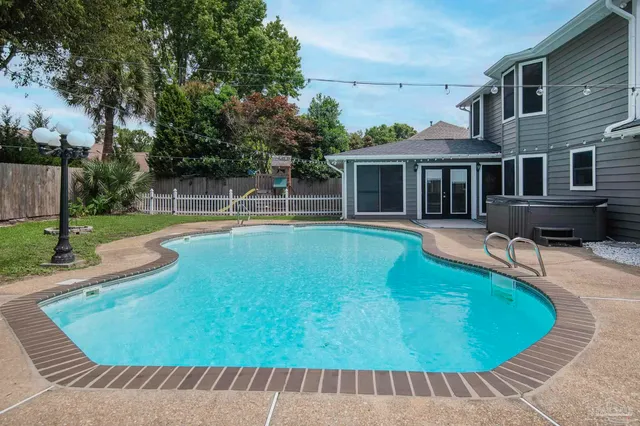 a view of a house with swimming pool and porch