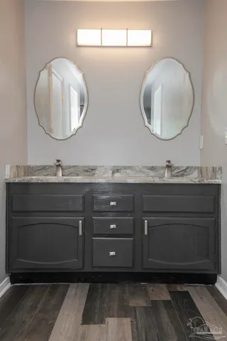 a bathroom with a double vanity sink and a mirror
