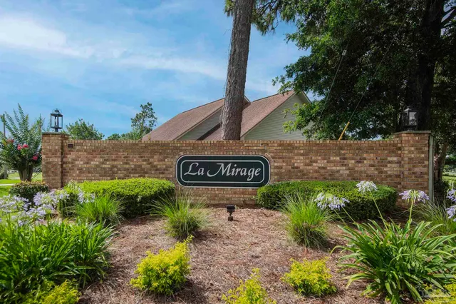 a sign that is sitting in front of flowers