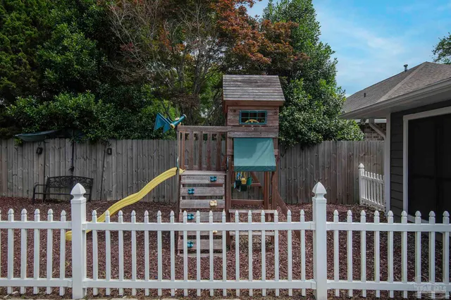 a view of a deck with furniture and wooden fence