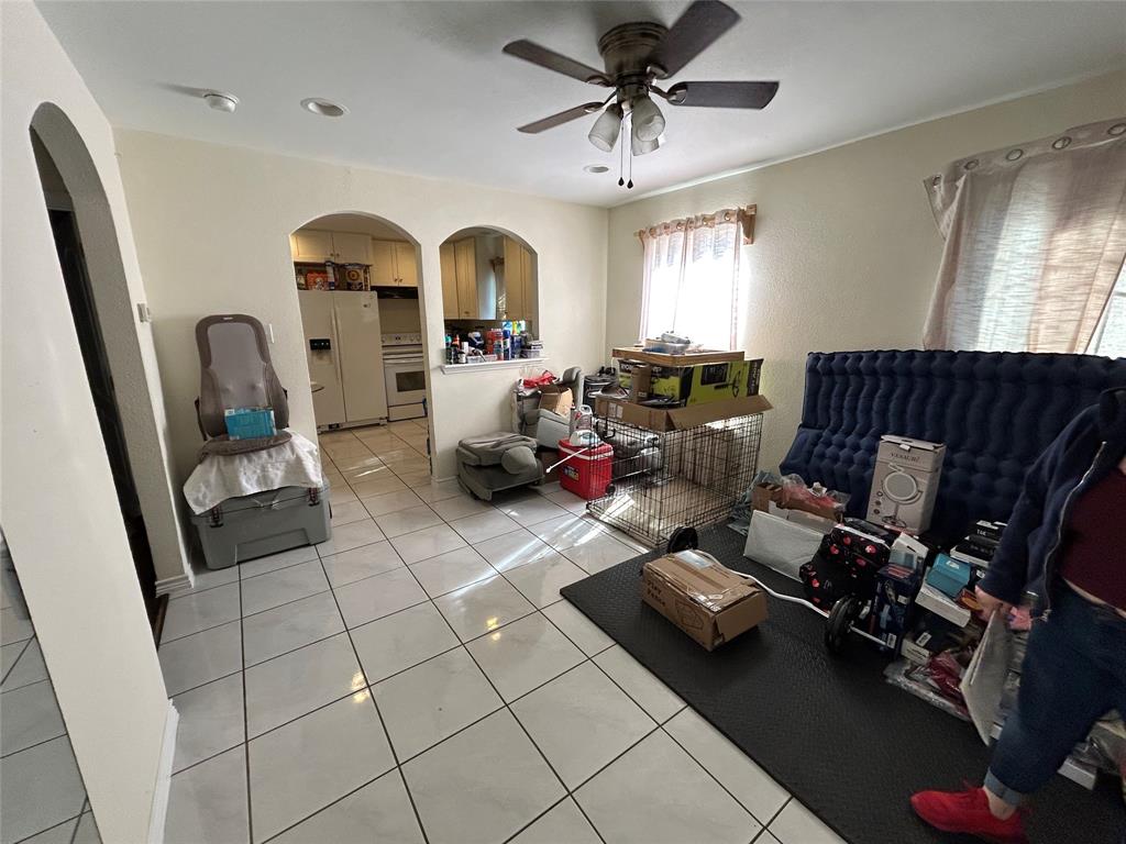 3702 Frank Street Dallas, TX 75210 - Photo 2 of 8 a living room with patio furniture and a chandelier