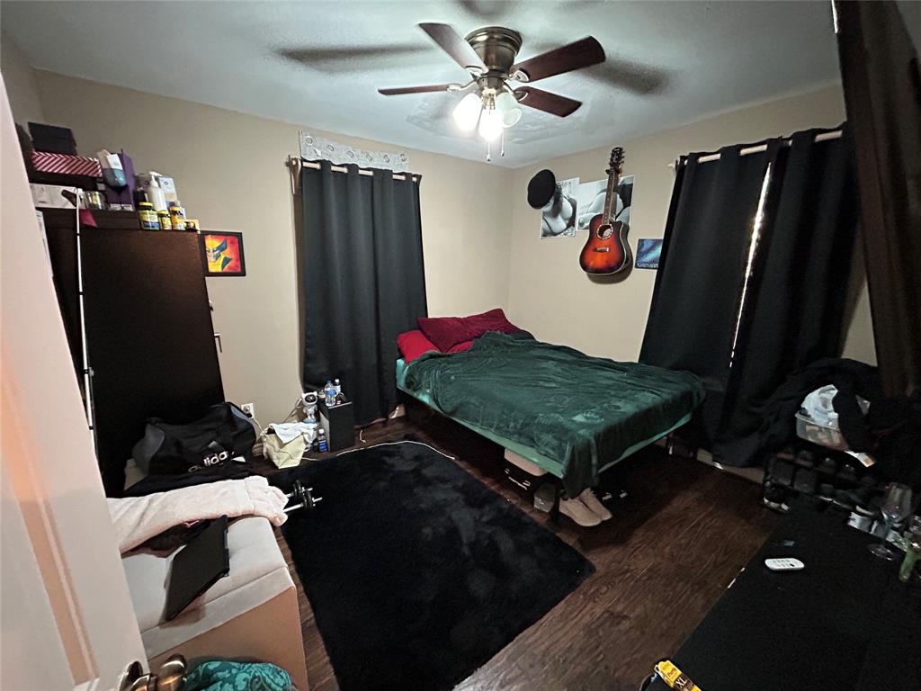 3702 Frank Street Dallas, TX 75210 - Photo 6 of 8 a living room with table chairs and a flat screen tv