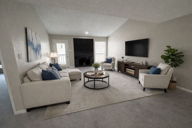 2277 South Kirkwood Road, Unit 104 Houston, TX 77077 - Photo 1 of 12 Living room with Fireplace and patio door to the left of the fireplace. (virtually Staged)
