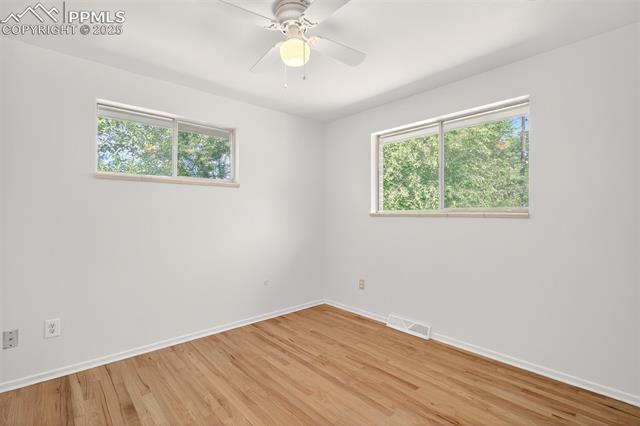 130 South Chelton Road Colorado Springs, CO 80910 - Photo 9 of 17 Bedroom with light wood-style flooring and a ceiling fan