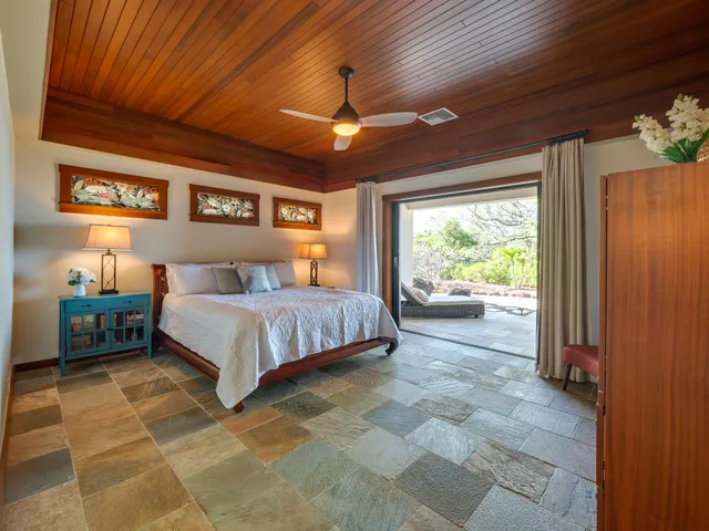 a spacious bedroom with a bed and a shower